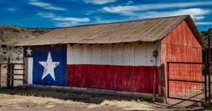 Texas flag painted on a barn in one of the Small Texas cities that are becoming popular among millennials
